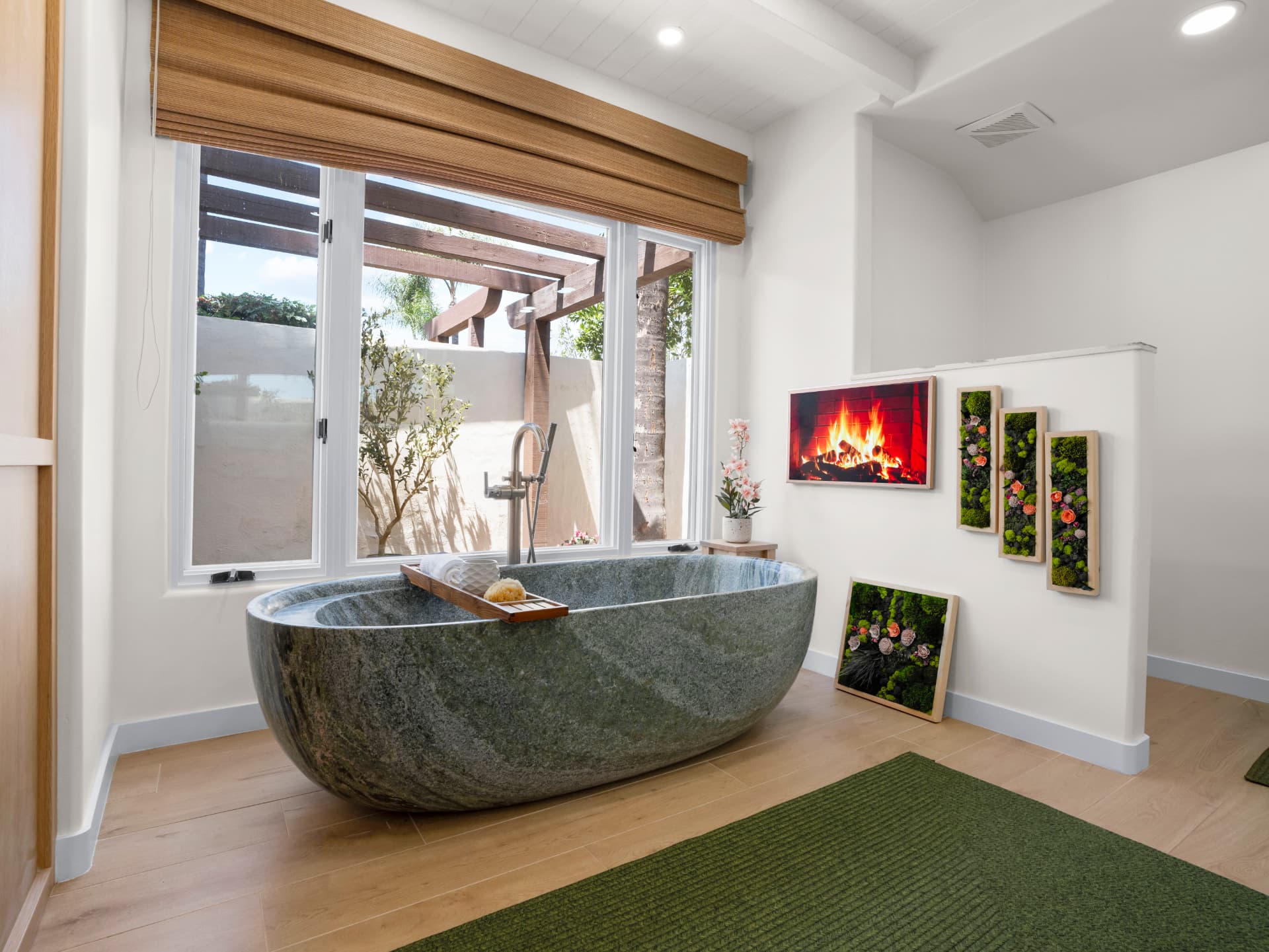 Primary bathroom with imported stone soaking tub beneath a garden window